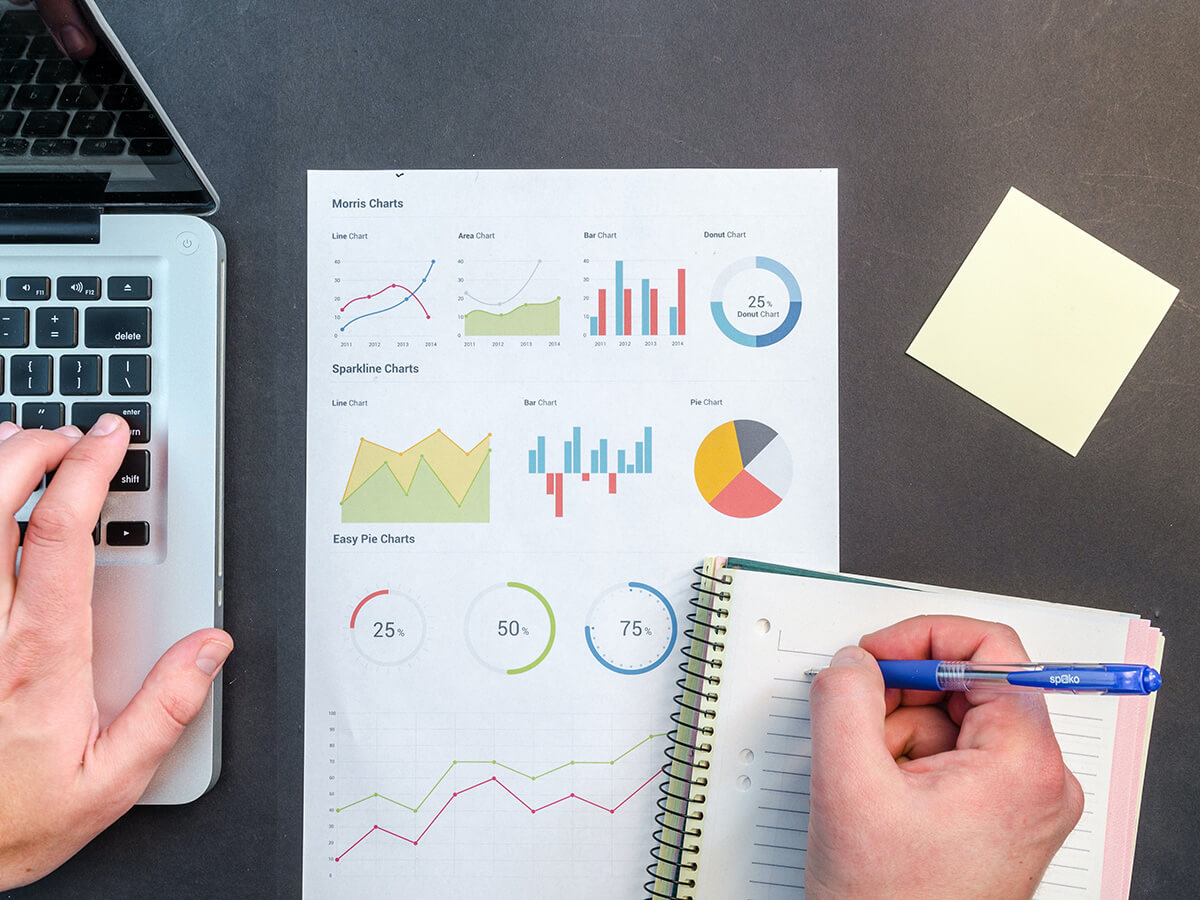 person writing on notebook