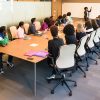 A group of people training for their business in a classroom.