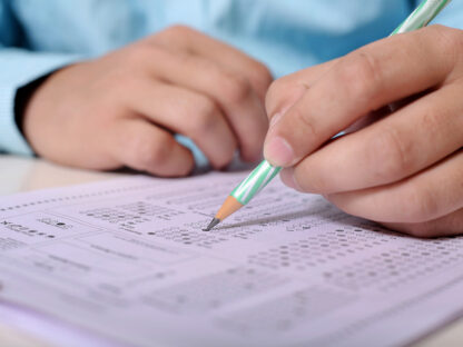 man filling out testing exam answer sheet