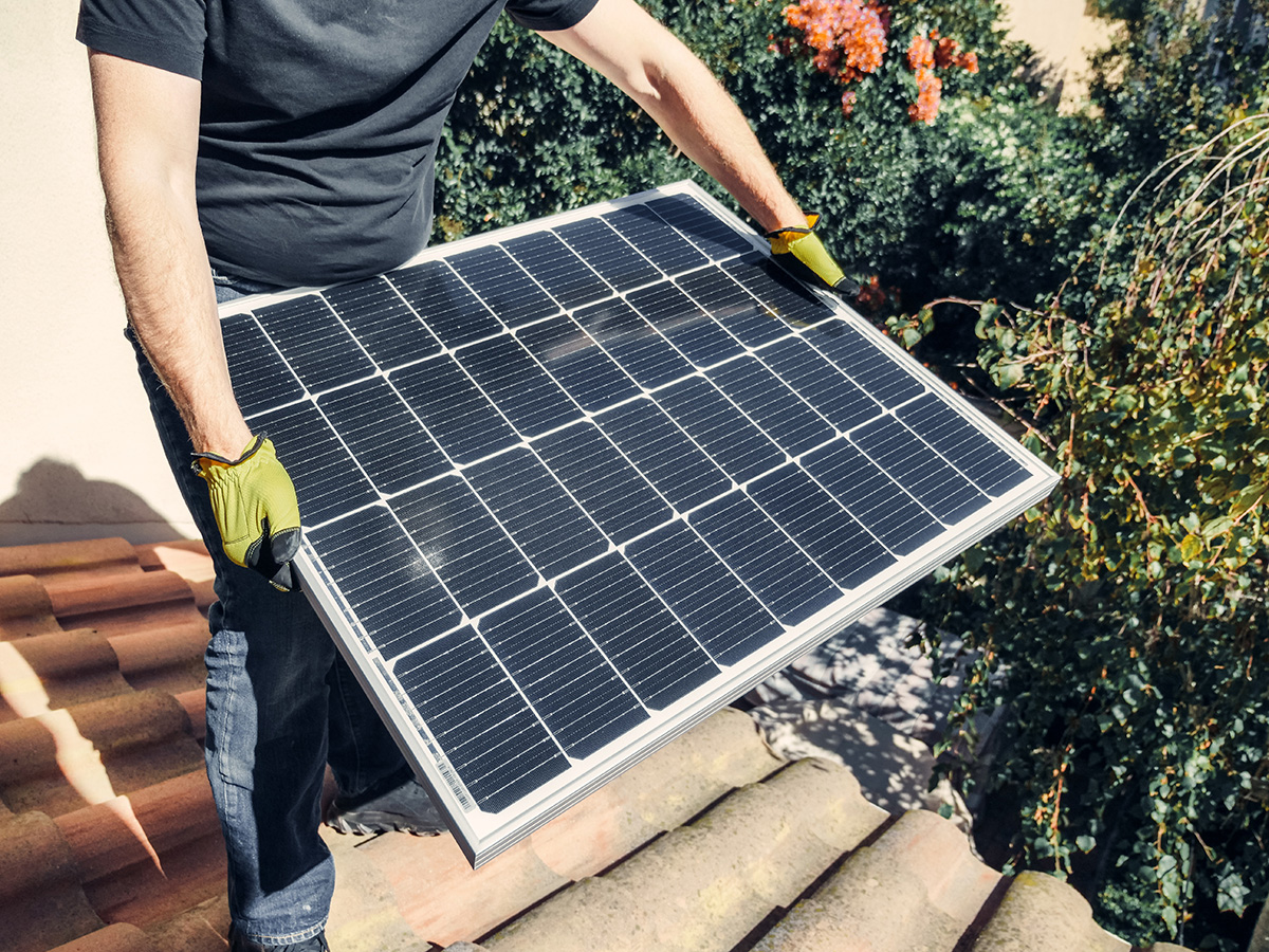 Man holding solar panel